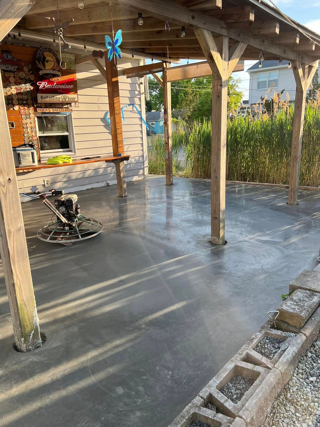Covered outdoor concrete patio pad alongside a residential home.